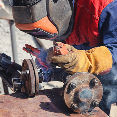 This welder on bench with pipe replaces Hispanic man with wrench in mech room